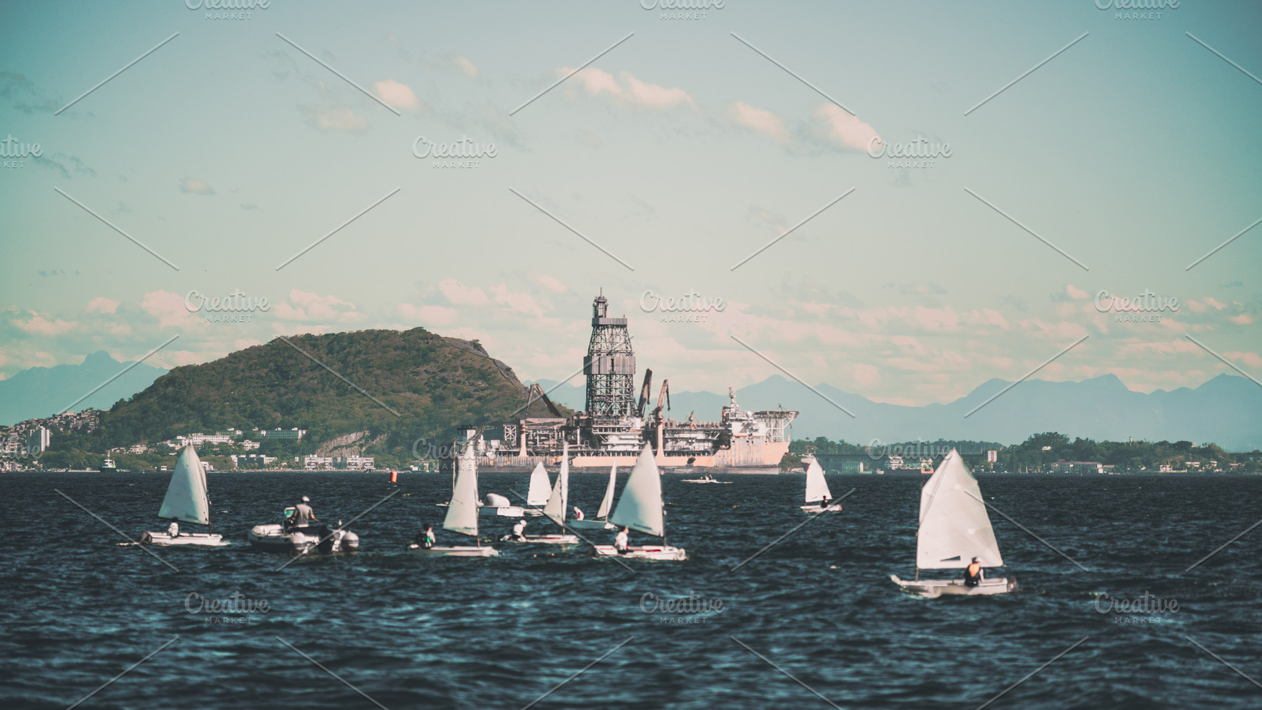 Sailboats with distant offshore rig, an Industrial Photo by SkyNext