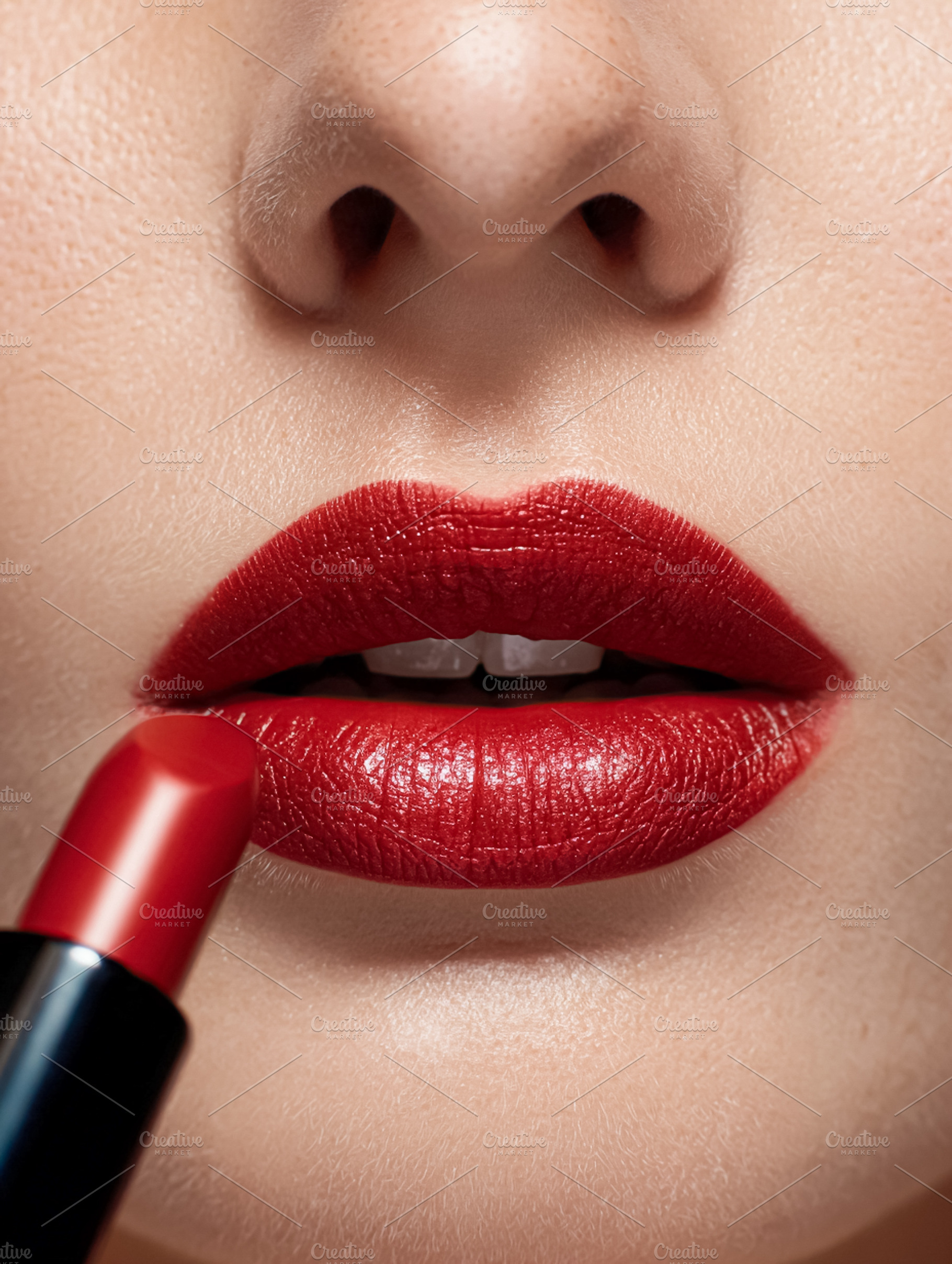 Woman applying bright red lipstick. Emphasizing beauty, fashion,, a Photo by Studio ANNA