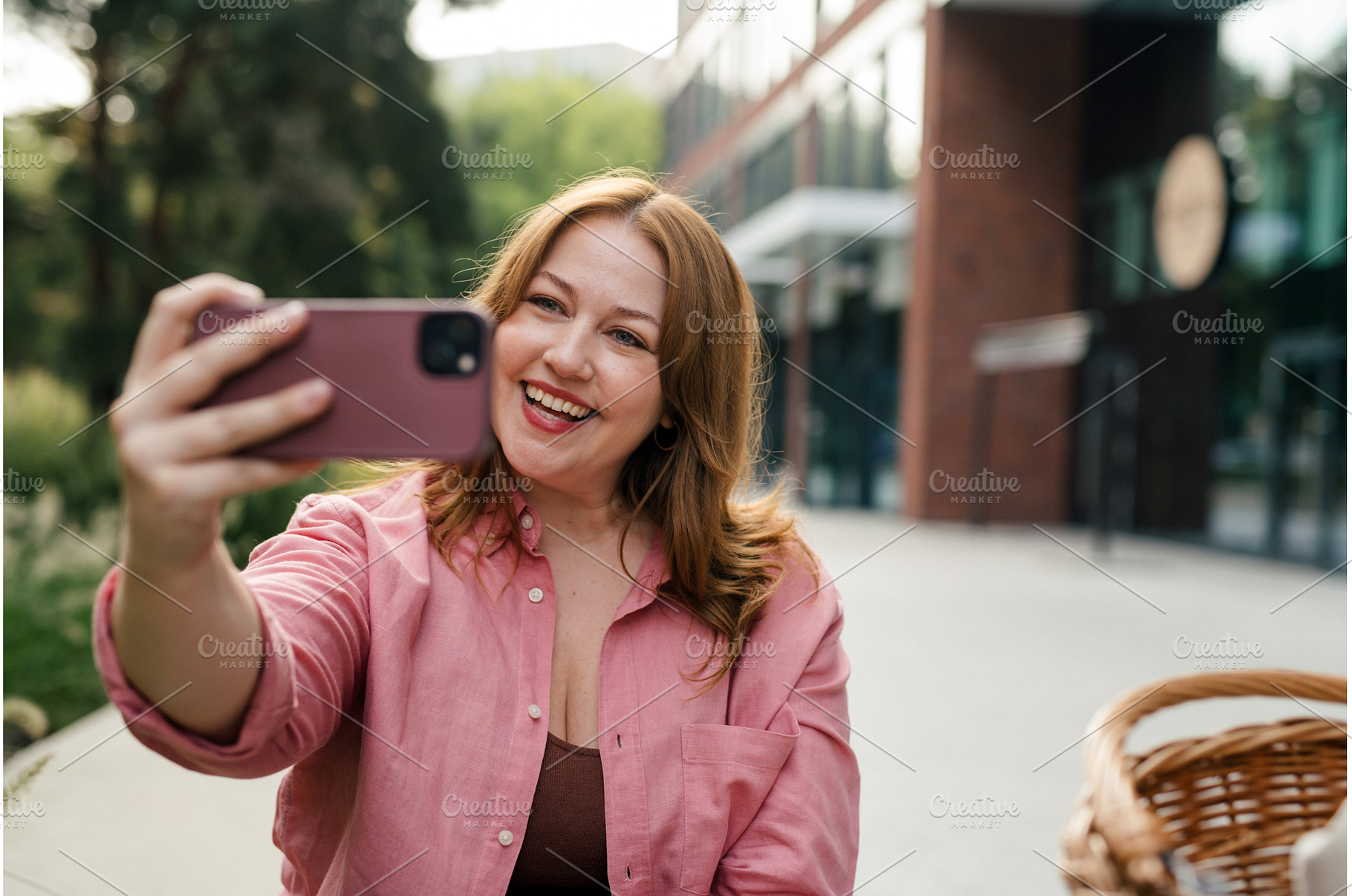 Curvy woman making videocall in park, a Business Photo by HalfPoint