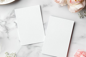 Two blank cards on marble desktop with pink roses, babies breath, and elegant d, a Holiday Photo by Studio ANNA