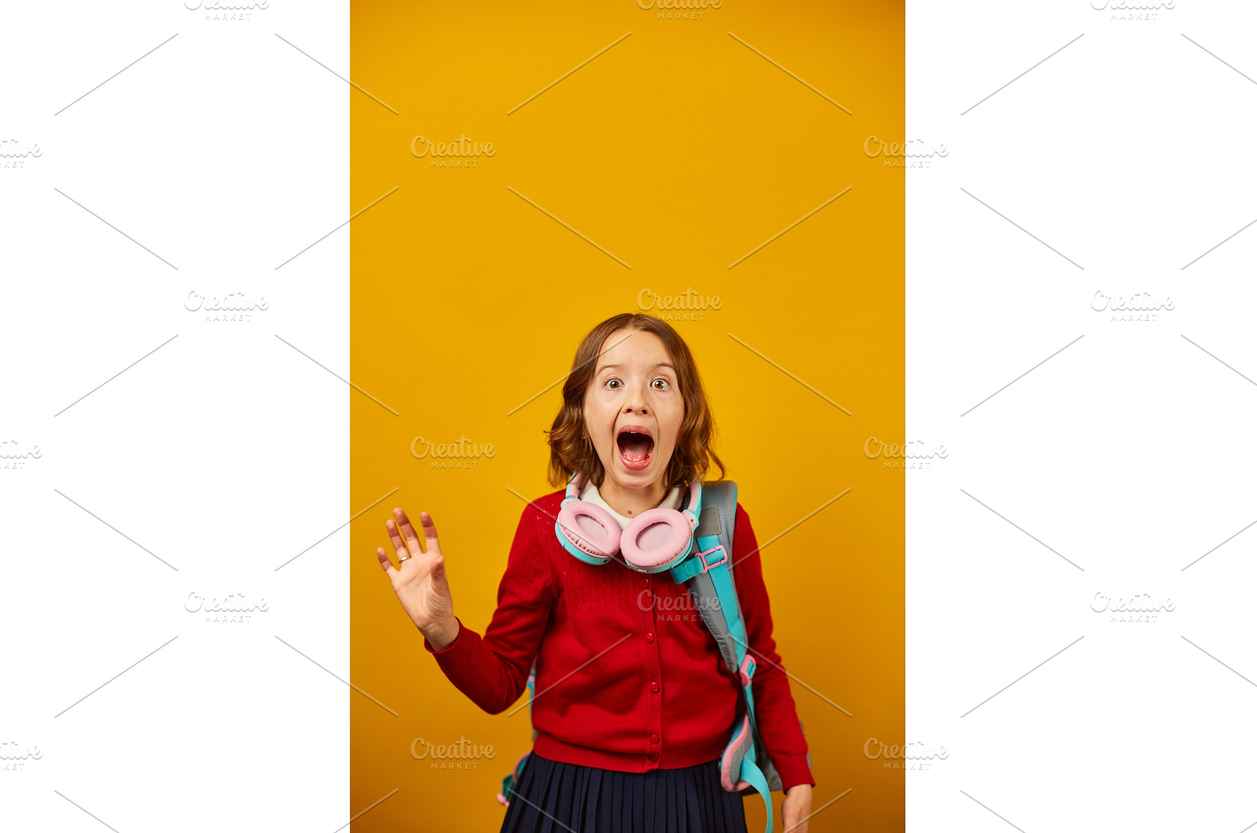 Excited girl wearing headphones, a School & Education Photo by IlliaBondarPhotography