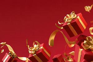 Christmas red gift boxes with golden ribbons on festive red back
