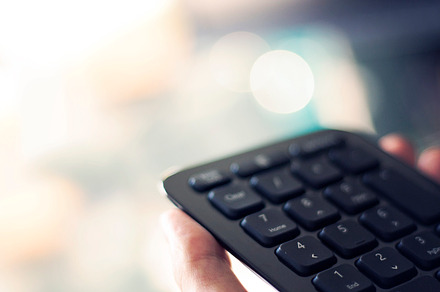 Hands holding calculator keyboard