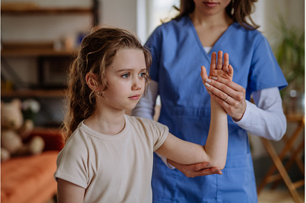 Little girl doing exercise with a, a Health & Medical Photo by HalfPoint