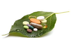 Vitamins tablets and pills on leaf stock photo containing antibiotic and