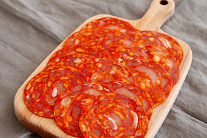 Cold Meat Chorizo Slices on a Wooden Board, side view., a Food & Drink Photo by LiudmylaChuhunova