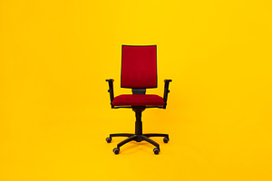 Front View Of Red Adjustable Office Chair Over Yellow Background, a Photo by Prostock-Studio