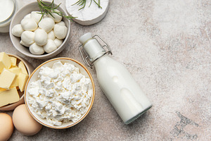 Assortment of fresh dairy products on textured background, a Food & Drink Photo by Olena Rudo