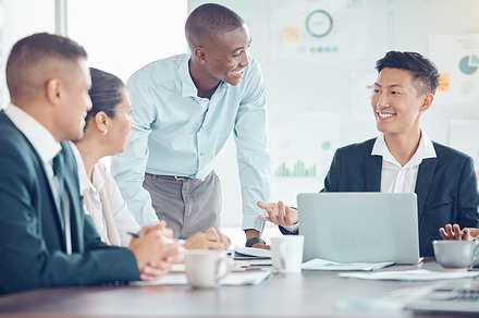 Smile, marketing and employees meeting, planning and working on a strategy for their startup business. Happy, corporate and training workers talking about a partnership with a laptop in an office, a Photo by Peopleimages.com