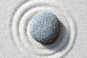 Pebble stone centered on white sand, a Wallpaper Photo by Virgo Studio
