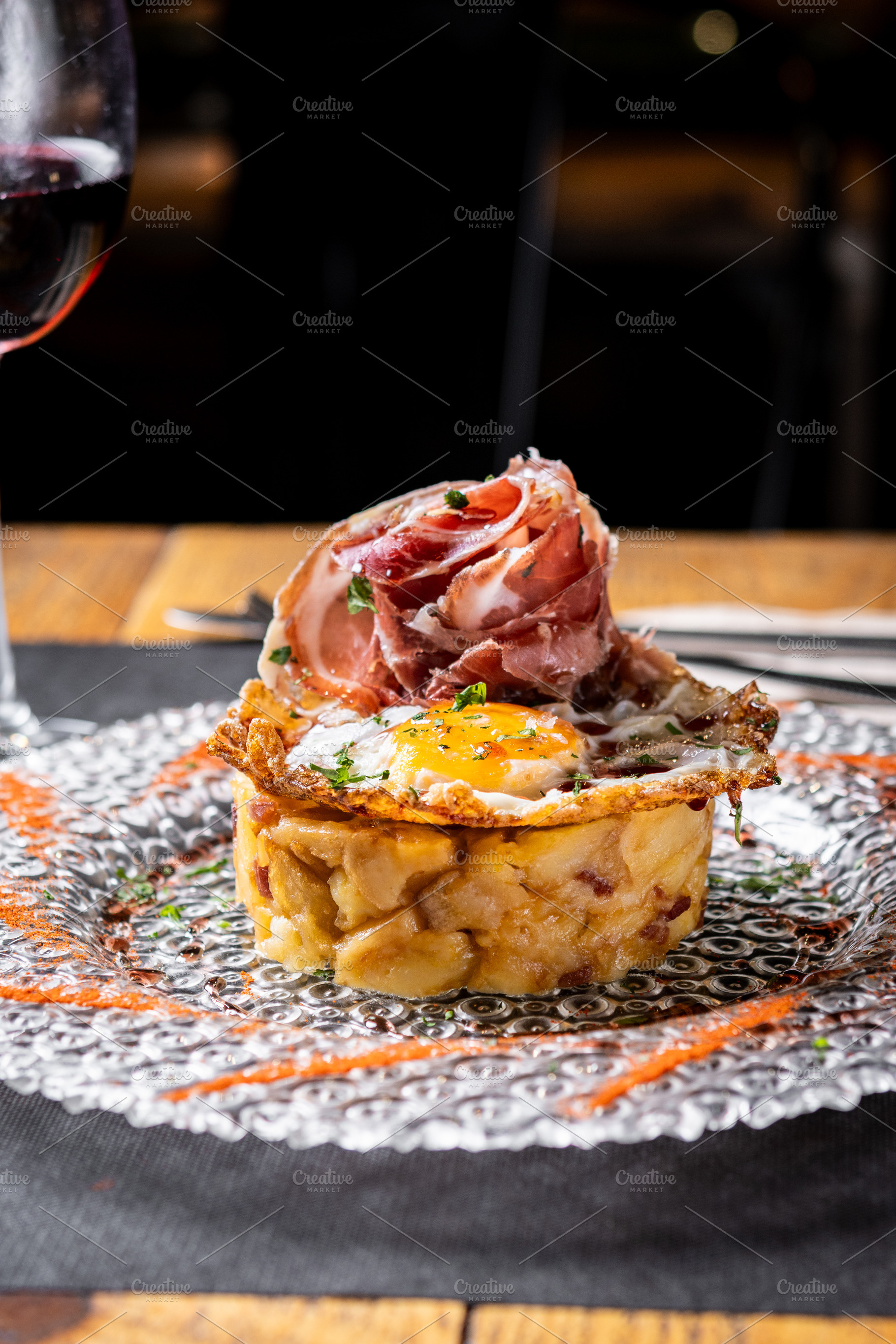 Traditional Spanish potato omelette with Iberian ham and crispy pork rind serve, a Food & Drink Photo by etorres69