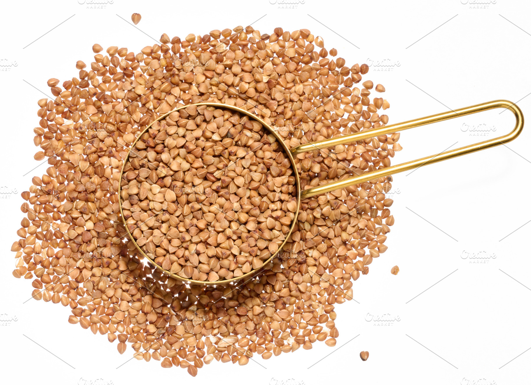 Raw buckwheat grains on isolated background, close up, a Food & Drink Photo by ndanko