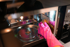 Hand in glove wipes the microwave