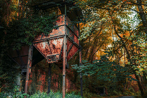 Rusty structure in autumn forest, an Industrial Photo by SkyNext