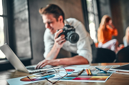 Young cheerful photographer, a Photo by ORION Production