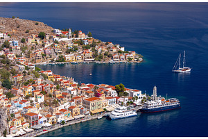 Cruise ship in Symi harbor with, an Architecture Photo by kavalenkava