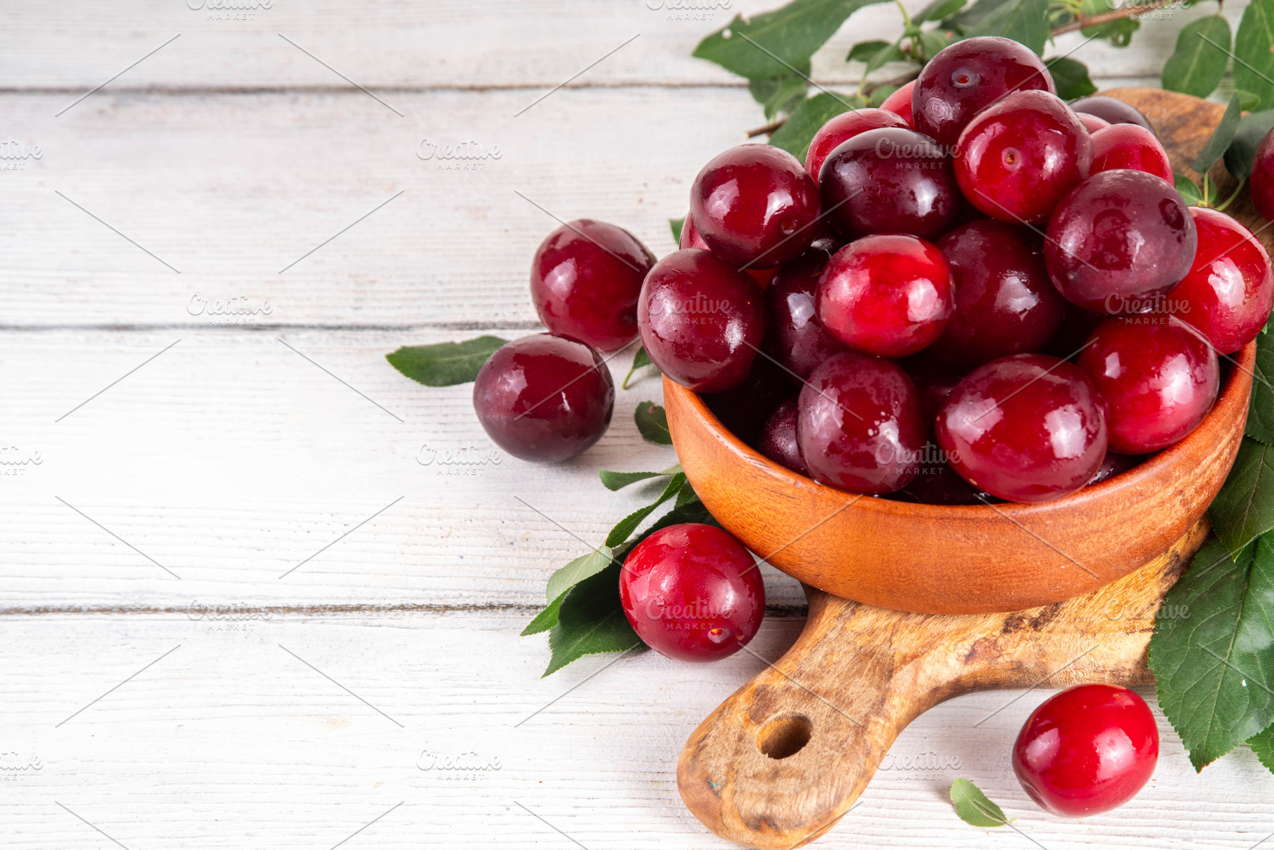 Fresh raw ripe cherry plum with leaves, a Food & Drink Photo by Rimma