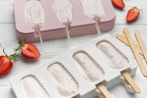 Preparing homemade strawberry ice cream bars in silicone molds, a Food & Drink Photo by Olena Rudo