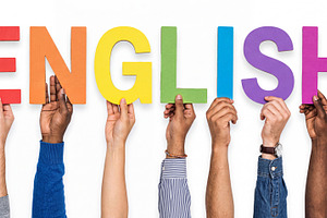 Diverse multiracial hands holding colorful cardboard letters for