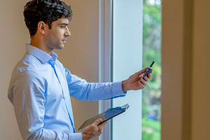 Home inspection audit by professional near window, a Photo by DanFLCreativo