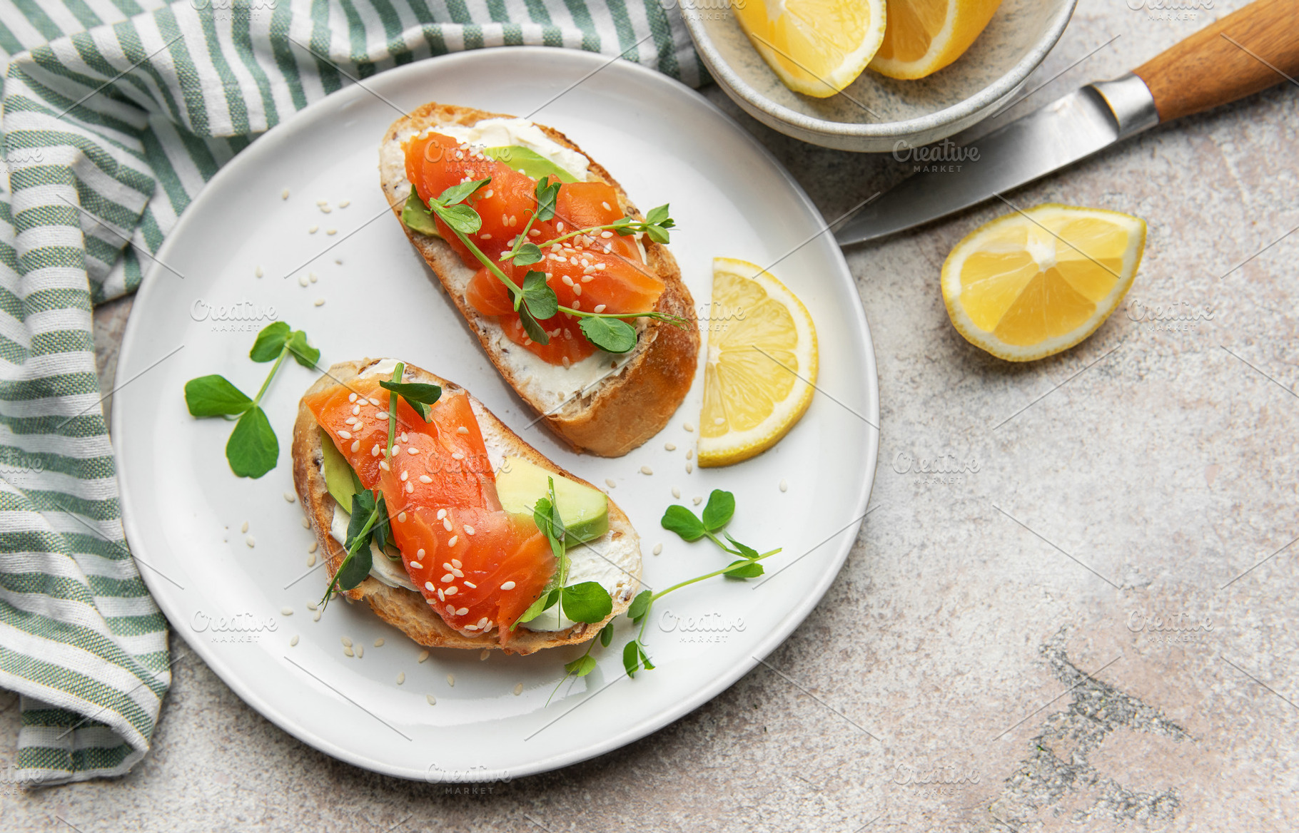 Salmon avocado toasts with microgreens and lemon, a Food & Drink Photo by Olena Rudo