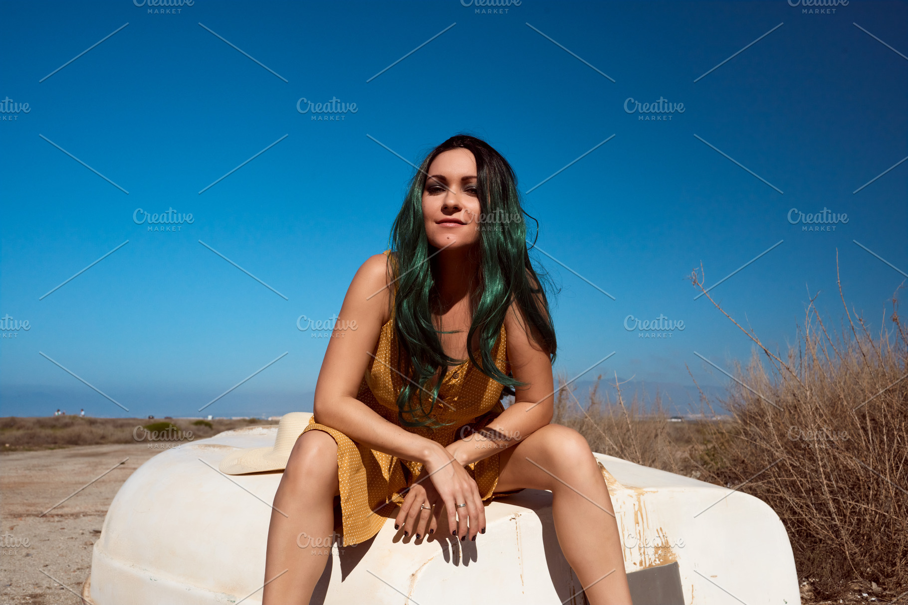 a girl sitting on a boat stranded in a summer landscape, a Beauty & Fashion Photo by YossSabalet