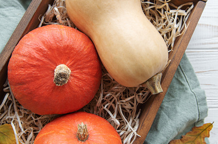 Autumn decorative pumpkins with fall leaves on wooden background, a Food & Drink Photo by Olena Rudo