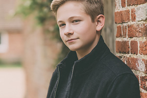 Young blonde boy standing outdoors, looking forward, leaning aga, a Person Photo by Studio ANNA