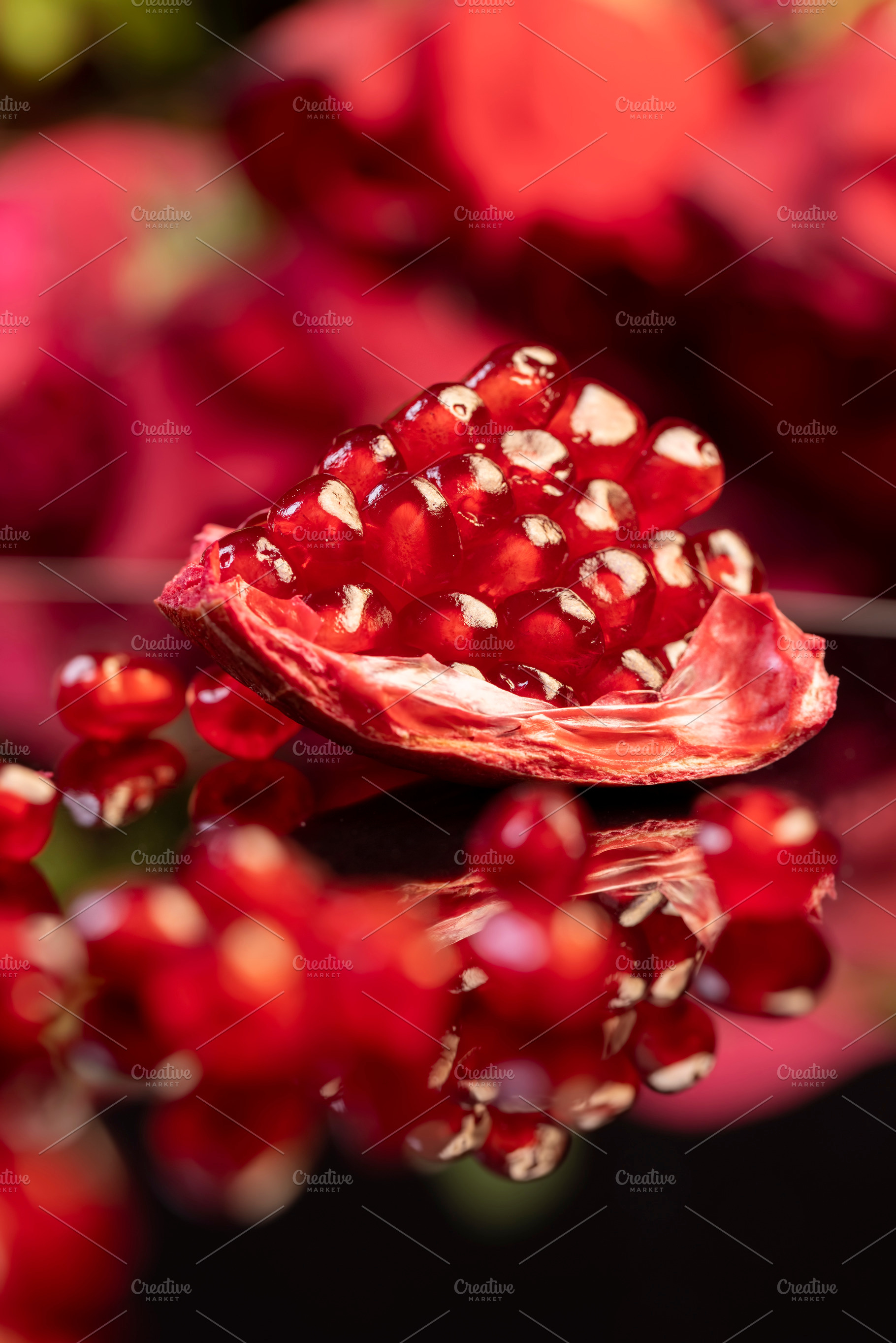 peeled ripe red pomegranate with juicy grains, reflection of a grenade in glass, a Photo by rsoollAI