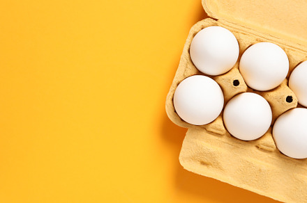 Egg box with eggs, space for text, a Food & Drink Photo by AtlasStudio PRO