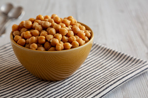 Organic Raw Canned Chickpeas in a Bowl, low angle view. Copy spa, a Food & Drink Photo by LiudmylaChuhunova