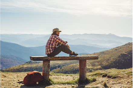Male Hiker Resting on Top of the