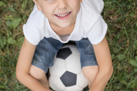 Young boy with soccer ball stock photo containing sport and football