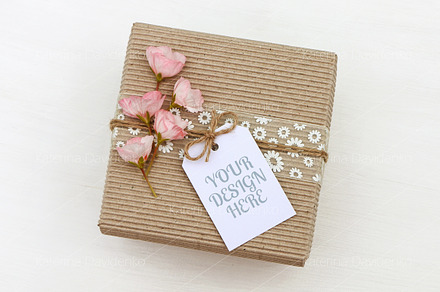 Gift box with empty tag mockup, a Background Photo by Bubert Art