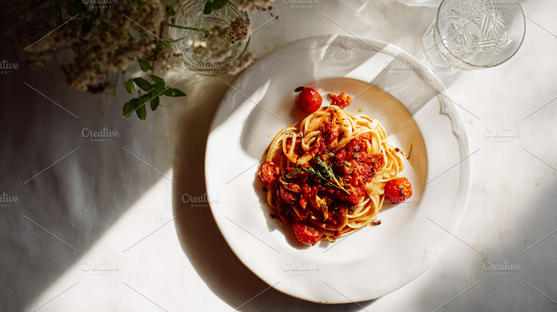 Lunch on a table, pasta with tomato sauce, cherry tomatoes, and, a Photo by Studio ANNA