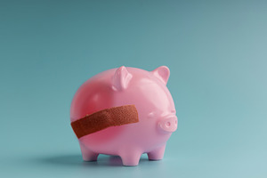 Piggy bank with bandage on pastel background,Economic crisis, a Photo by salmon.black