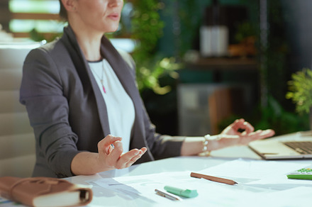 Closeup on relaxed modern business woman at work meditating, a Person Photo by Alliance Images
