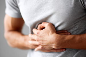 Man experiencing stomach pain, a Health & Medical Photo by MistyDay