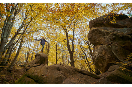 Woman standing on big old boulder in, a Nature Photo by vitaliymateha photography