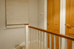 Modern home interior with carpeted stairs, wooden railing, and n, a Photo by Studio ANNA
