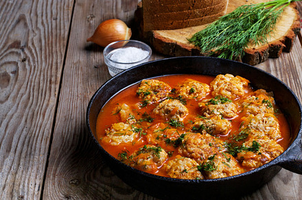 Meatballs in a pan on rustic featuring onion, meal, and balls