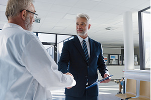 Portrait of manager shaking hand, a Health & Medical Photo by HalfPoint
