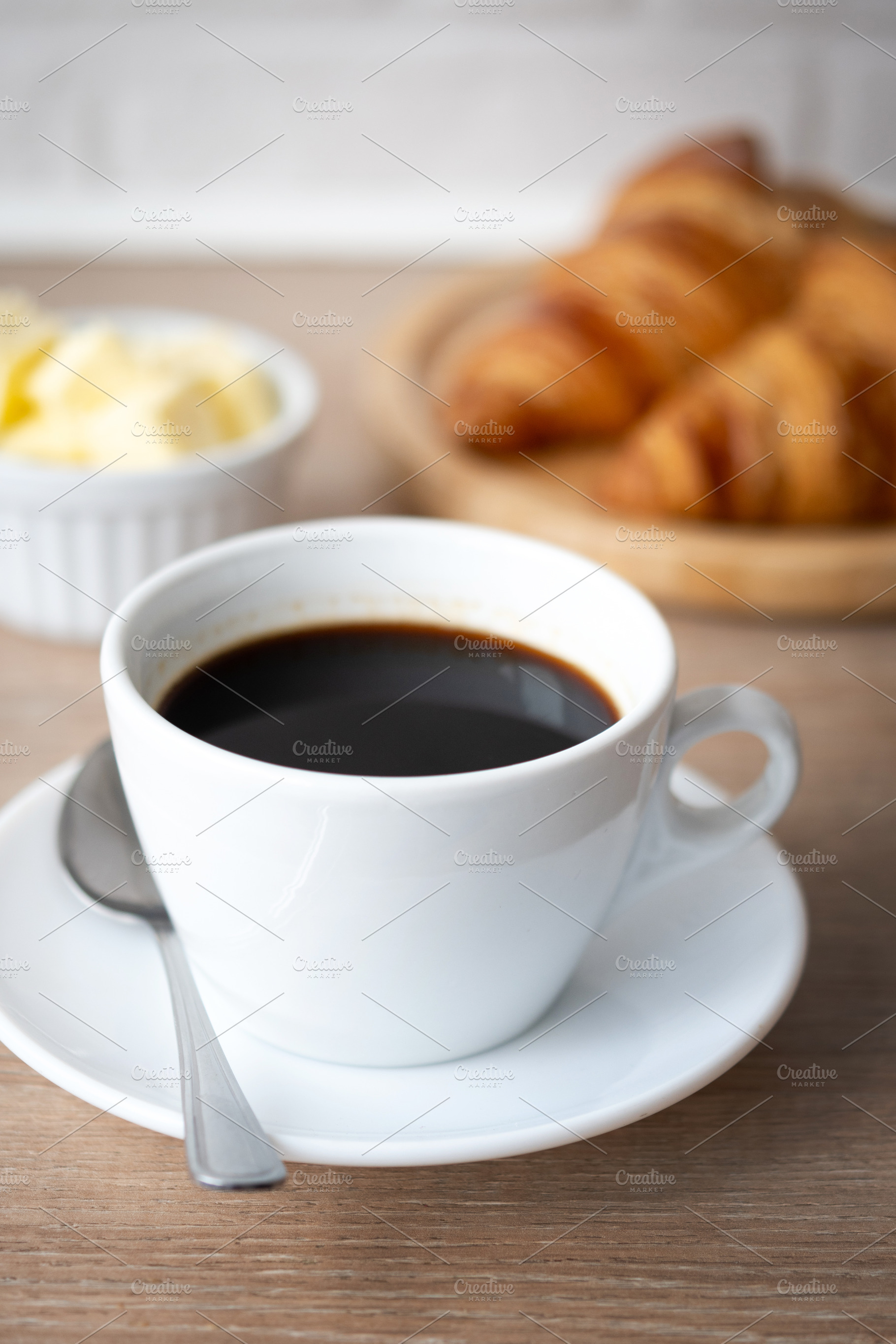 Black coffee with croissants and butter, a Food & Drink Photo by etorres69