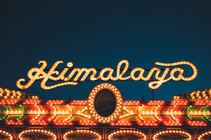 Himalaya fair ride containing fair, ride, and sign