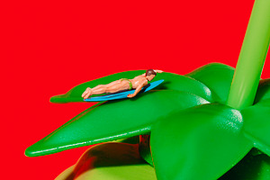 miniature man on surfboard on a bottle, a Photo by Nito