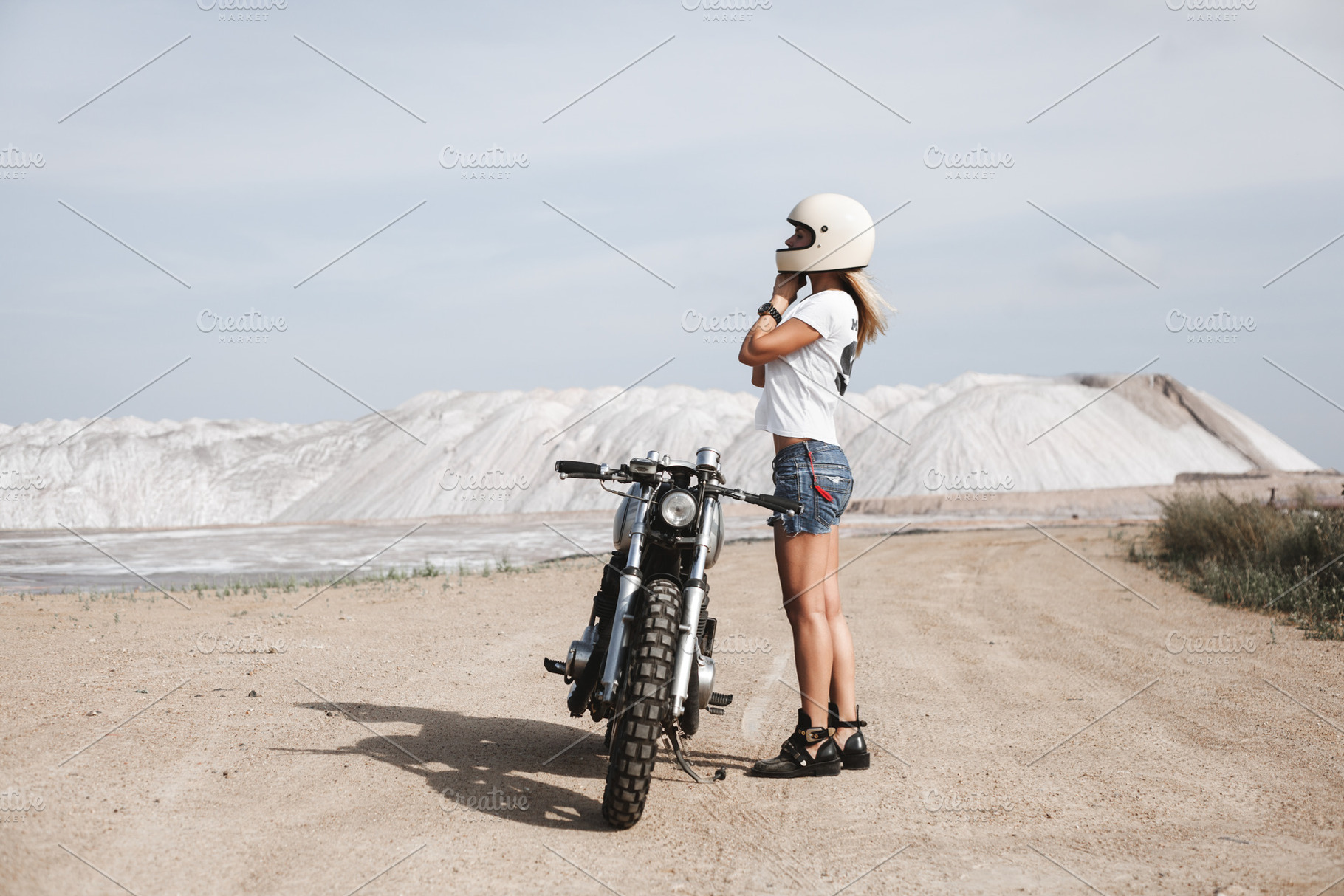 Sexy girl biker and cafe racer motorcycle containing wheels, motorcyclist, a Transportation Photo by Aliaksei Kaponia