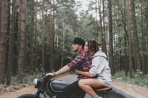 Caucasian couple on motorcycle containing woman, girl, and man, a Transportation Photo by Aliaksei Kaponia