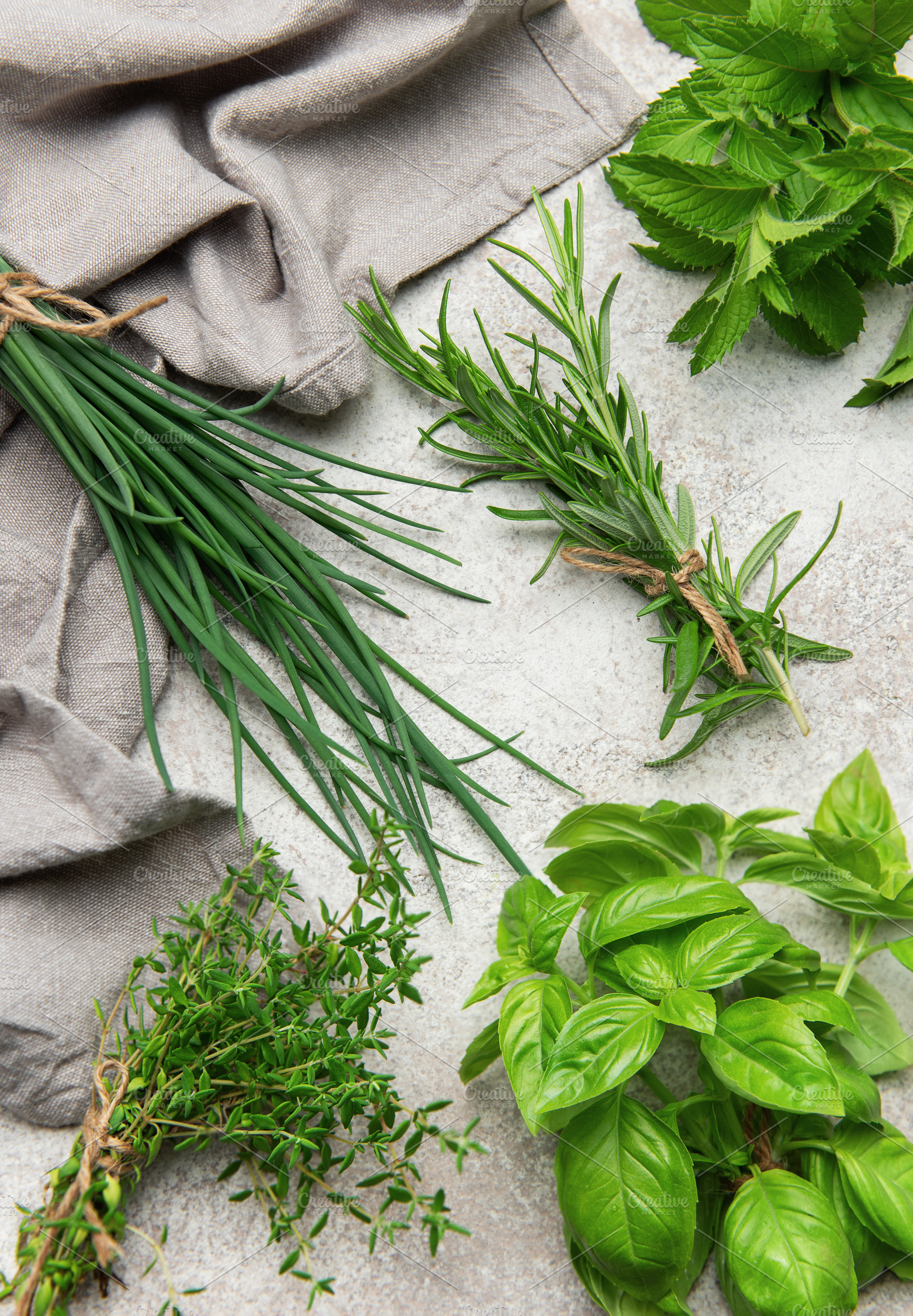 Freshly picked herbs of thyme, basil, mint, rosemary and chives, a Food & Drink Photo by Olena Rudo