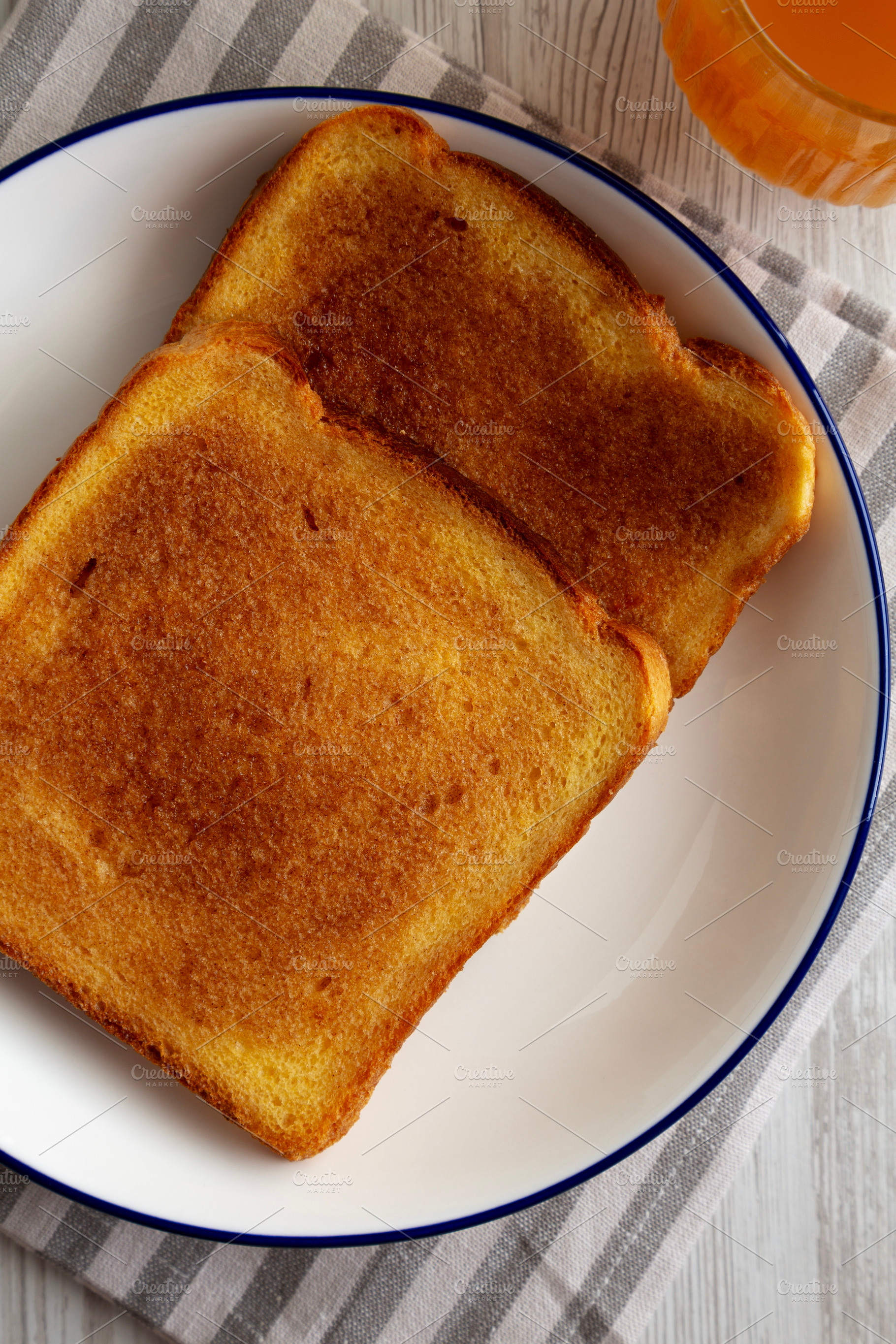 Homemade American Cinnamon Toast with Butter and Orange Juice, t, a Food & Drink Photo by LiudmylaChuhunova