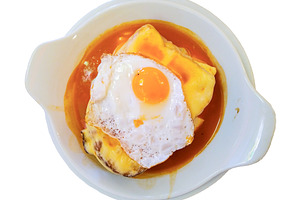 Francesinha sandwich with egg and spicy sauce, a Food & Drink Photo by DanFLCreativo